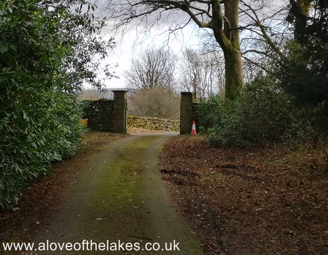 The path leads to the perimeter wall of the Bigland Hall estate
