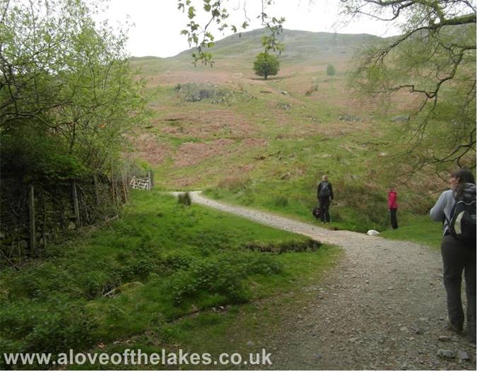 The path leads on to the open fellside